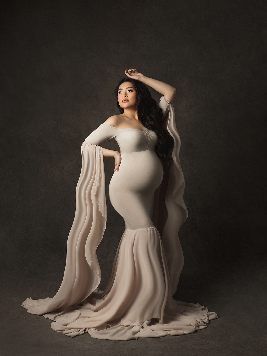 8s Studio maternity portrait — pregnant woman in dramatic pose, fine art photography with graceful and timeless elegance.
