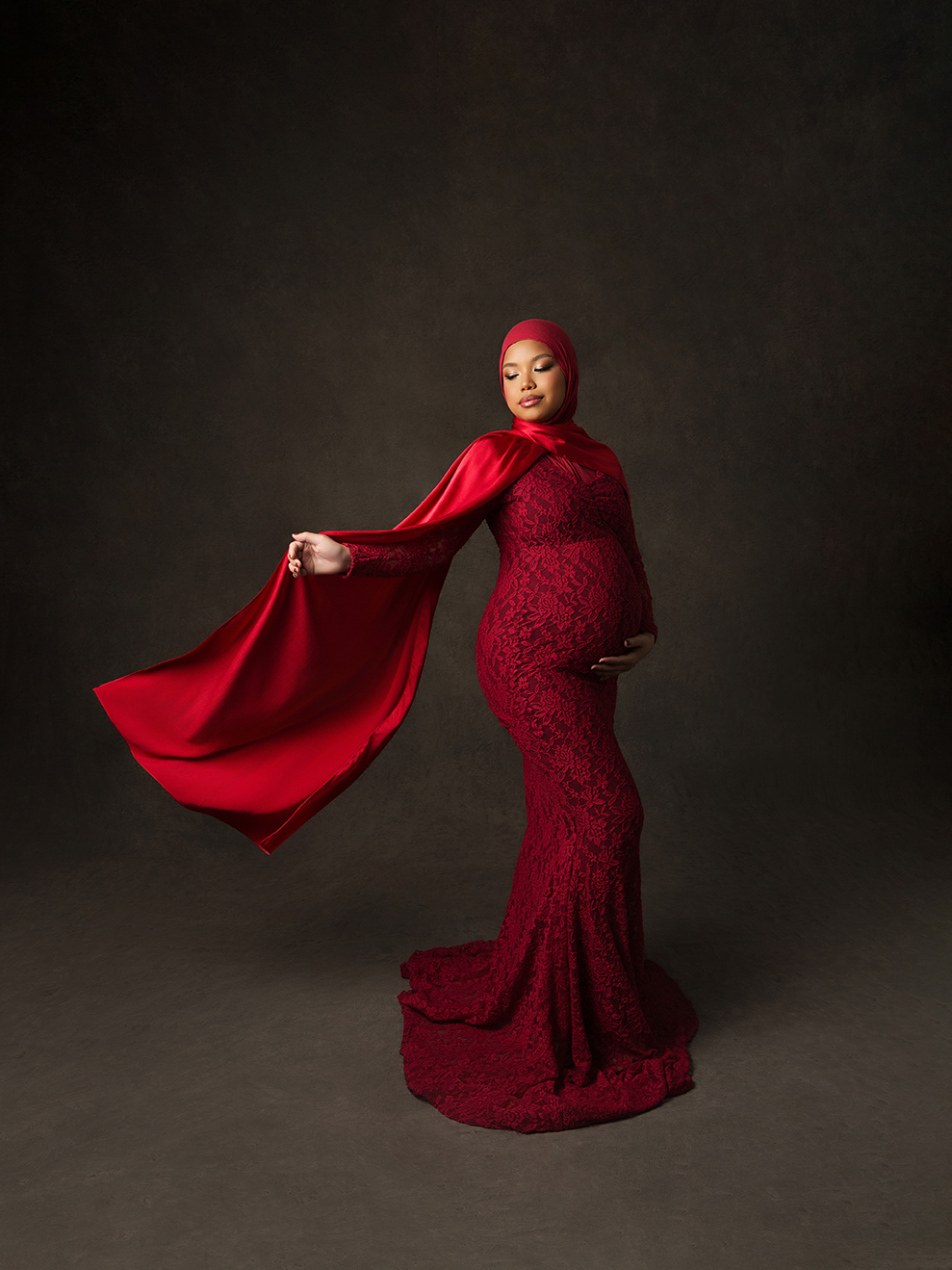 XIAOYUN PHOTOGRAPHY Muslim maternity portrait of pregnant woman in red lace gown and tudung with flowing cape, studio fine art style